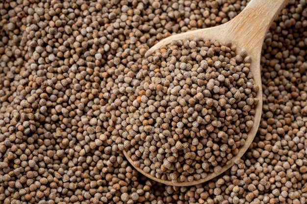 Closeup Perilla seeds in a wooden spoon are grains that can be eaten with both seeds and leaves