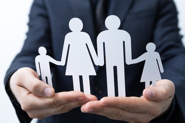 Closeup of a person holding a family paper cut out under the lights