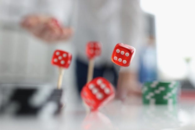 Closeup of person throwing dice addiction to gambling concept