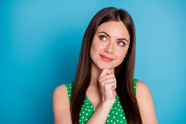 Closeup photo of attractive pretty lady charming cute appearance hold arm on chin intelligent creative clever person wear green dotted tank-top top singlet isolated blue color background