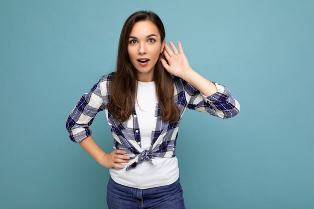 Closeup photo of beautiful attractive shocked amazed surprised young woman with open mouth wearing casual clothes isolated over colourful wall with empty space.