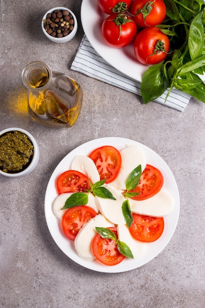 Closeup photo of caprese salad with ripe tomatoes basil buffalo mozzarella cheese Italian and Me