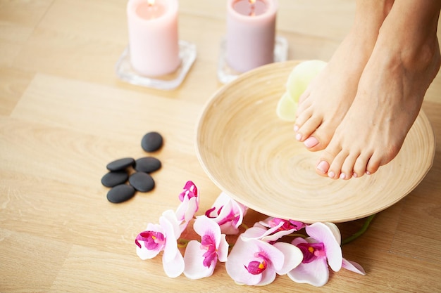 Closeup photo of a female feet at spa salon on pedicure procedure