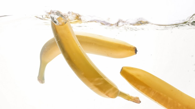 Closeup photo of fresh ripes fruits falling in water