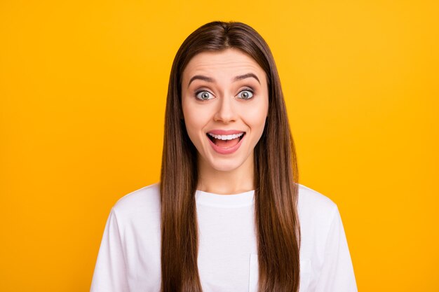 Closeup photo of funky crazy pretty lady long perfect groomed hairstyle listen amazing news open mouth wear casual white t-shirt isolated vibrant yellow color wall