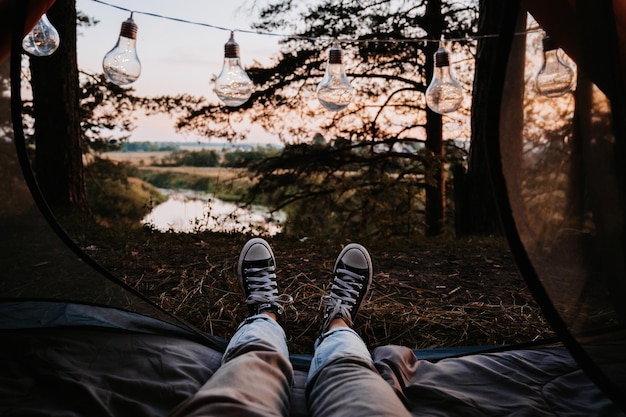 A closeup photo of the intentions of women's legs The concept of a tourist trekking expedition View from the tent to the landscape