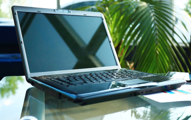 Closeup photo of laptop computer with open top. Blank screen