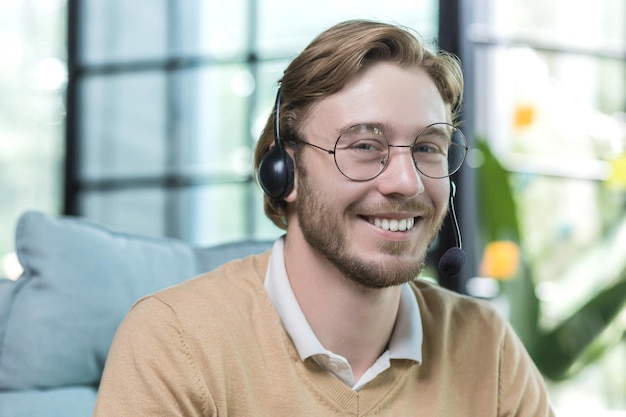 Closeup photo of man wearing headset for video call businessman working inside office building