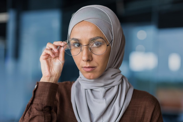 Closeup photo portrait of young beautiful arab woman in hijab he looks confidently into the camera