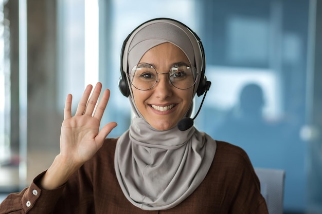 Closeup photo portrait of young beautiful muslim business woman tech support worker in hijab and