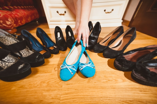 Closeup photo of woman picking ballet flats rather than high heels