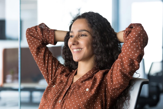 Closeup photo of a young beautiful business woman entrepreneur resting in the office looking out the