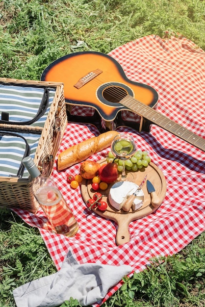 Closeup of picnic basket with drinks and food on the grass