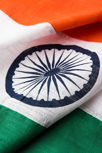 Closeup picture of indian flag made up of pure cotton or khadi, showing texture and folds, selective focus