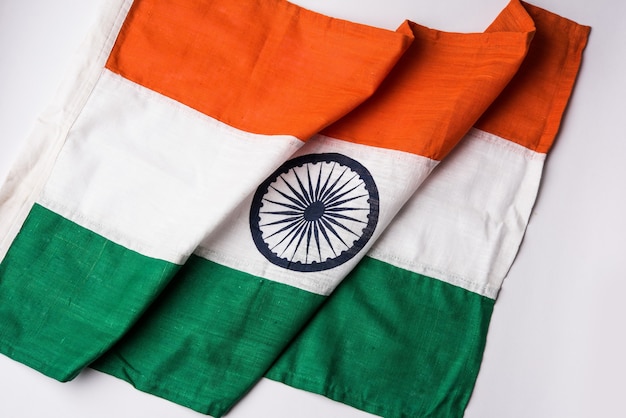 Closeup picture of indian flag made up of pure cotton or khadi, showing texture and folds, selective focus