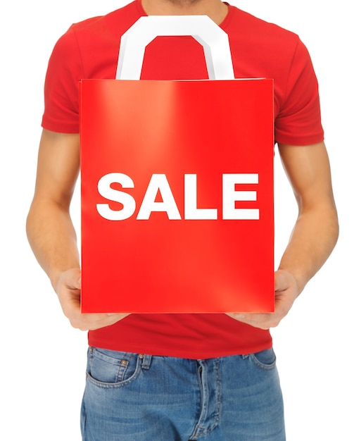 closeup picture of man's hands holding shopping bag