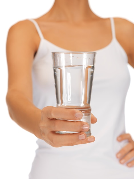 closeup picture of woman hands holding glass of water .