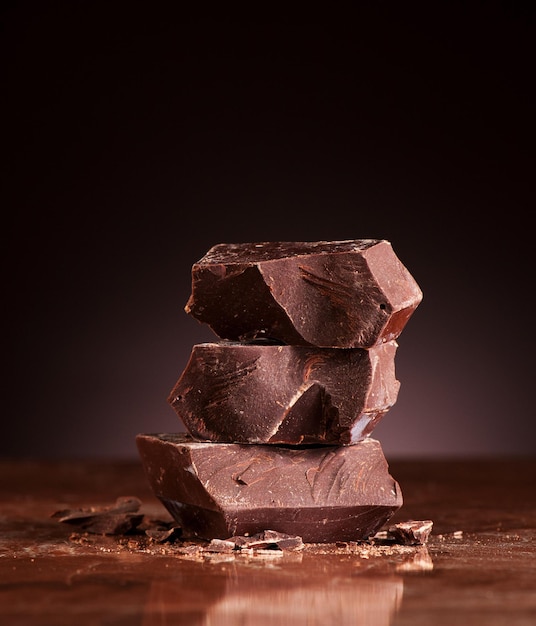 Closeup  pieces chocolate on a dark marble background