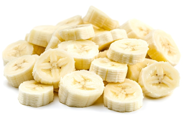 Photo closeup of a pile of sliced bananas on a white background