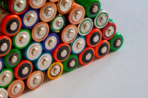 Closeup of pile of used alkaline batteries Several in rows