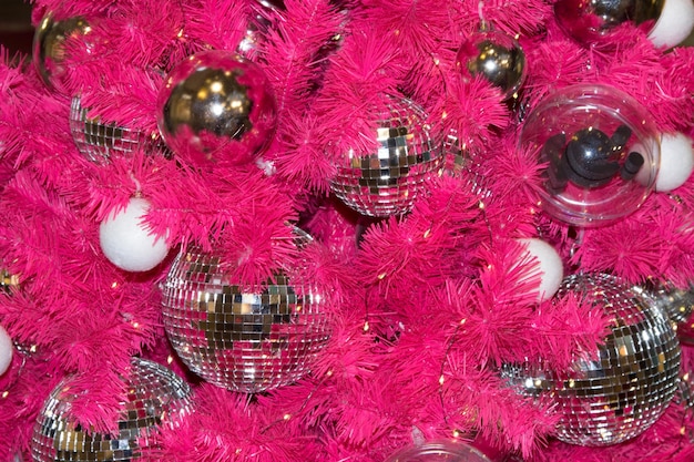 Closeup of a pink Christmas tree with shiny balls Christmas background