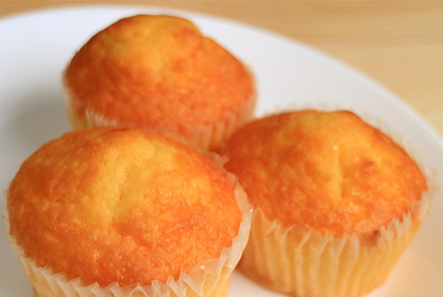 Closeup a Plate of Mouthwatering Madeleine Cupcakes with Selective Focus