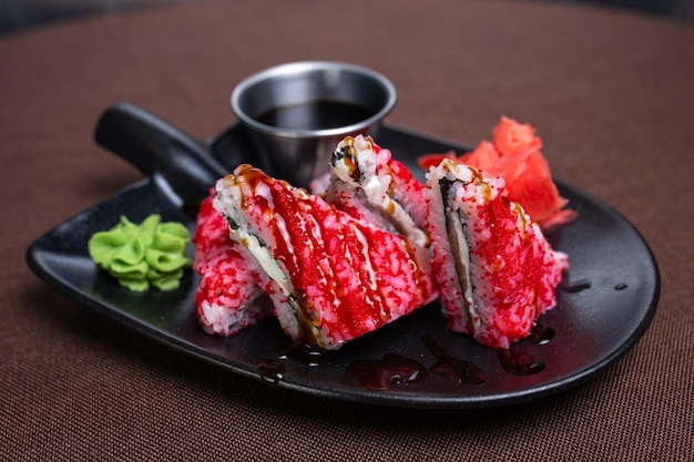 Closeup of a plate of sushi with chopsticks on a table