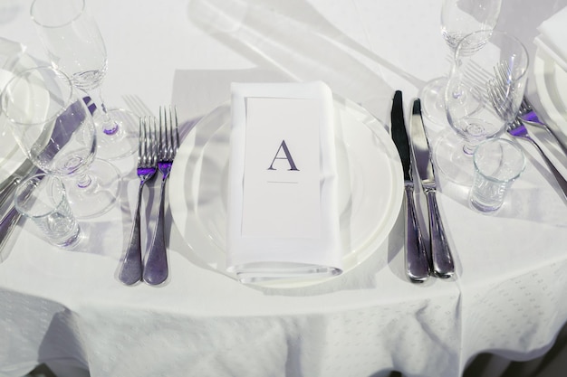 Closeup of a plate with a napkin and the name of the guest on the festive wedding table