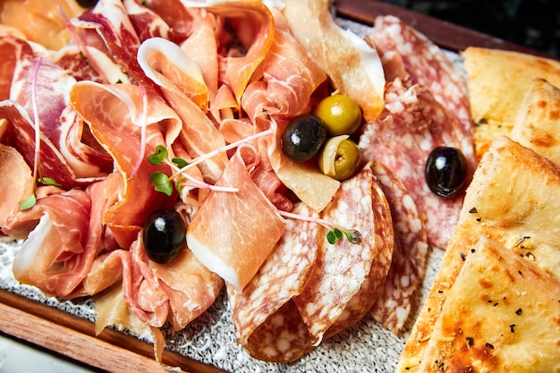 Closeup of a plate with various sliced dried delicacies