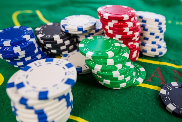 Closeup of poker chips on a green poker table