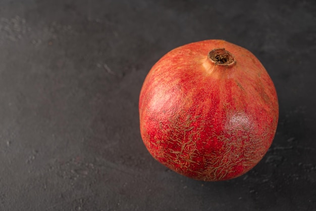 Closeup pomegranate against a dark background copy space close up