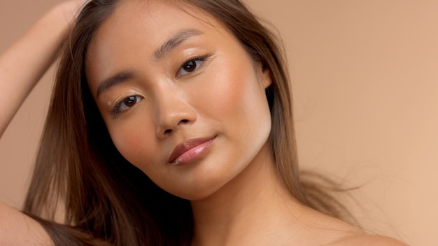 Closeup portrait of asian model touching her straight hair