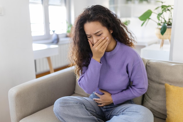 Closeup portrait of Asian unhappy annoyed sick woman about to chuck throw up puke retch barf Negative emotions feelings facial expressions Asian woman with morning sickness