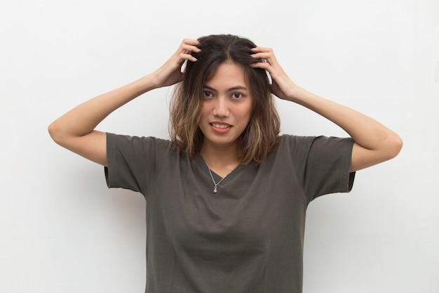 Closeup portrait of asian young woman scratching head with hand