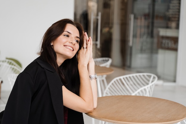 Closeup portrait of attractive smiling girl on white background Young woman enjoying lifestyle and dreaming about something