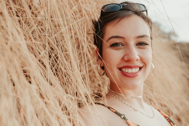 Closeup portrait of beautiful smiling young latin hispanic girl woman with short dark black hair bob