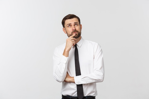 Closeup portrait of a casual young pensive businessman looking up