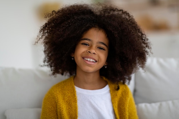 Closeup portrait of cheerful little black girl smiling at camera