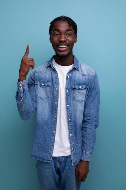 Closeup portrait of a cool fashionable african guy with dreadlocks in a denim jacket with insight