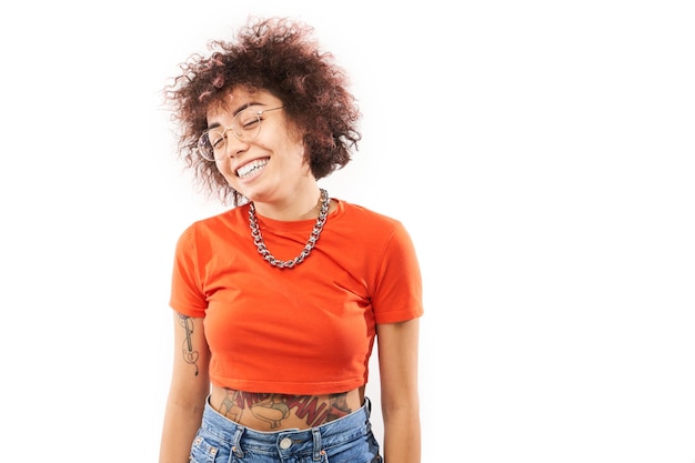 Closeup Portrait of cool happy kazakh model girl with curls tattoo and chain laughing and smiling isolated on white studio background