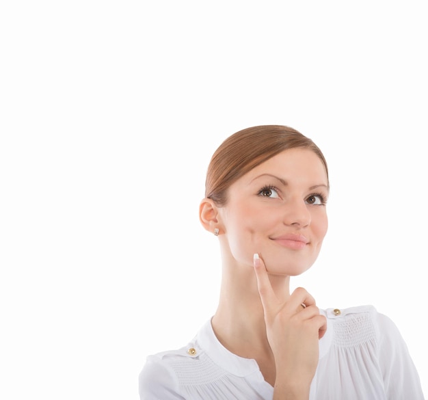 Closeup portrait of a dreaming young woman on white background