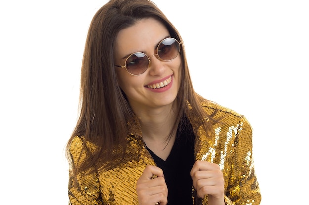 Closeup portrait of a glamorous young girl in a bright jacket and glasses isolated on white background