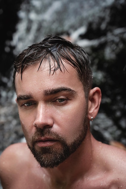 Closeup portrait of handsome bearded man with wet skin and hair