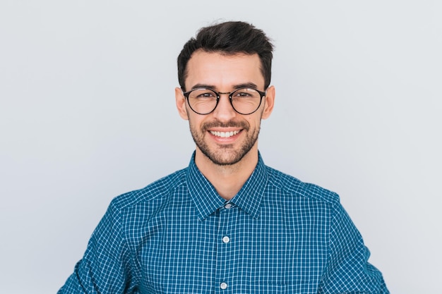 Closeup portrait of handsome smartlooking smiling with toothy smile male posing for social advertisement isolated on white background with copy space for your promotional information or content