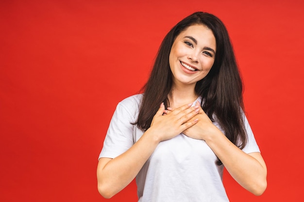 Closeup portrait of happy smiling brunette business girl woman in casual isolated over red background