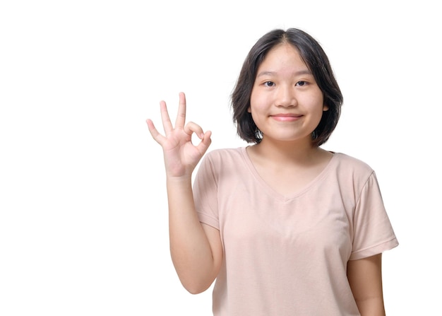 Closeup portrait of her she nice attractive lovely cheerful asian girl showing oksign ad solution good choice isolated on white background