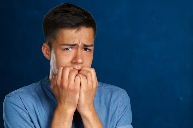 Closeup portrait of a man biting his nails