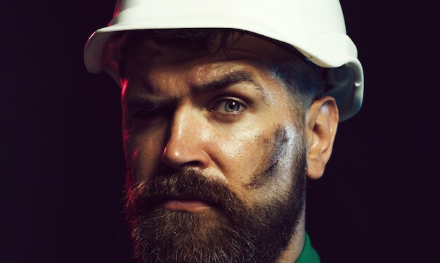 Photo closeup portrait of mechanical worker in hardhat industrial worker in in safety helmet construction