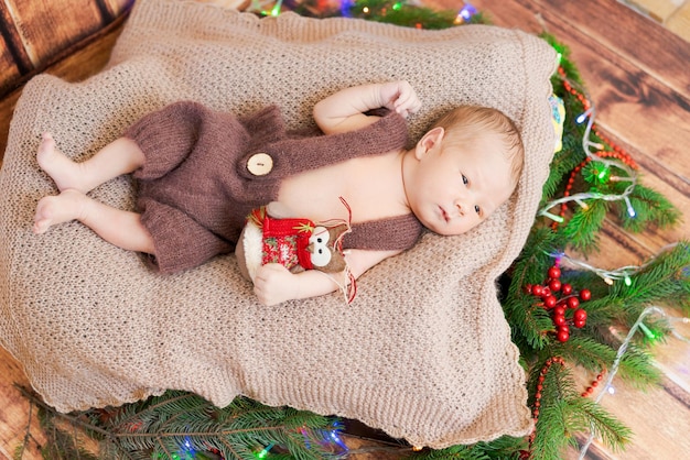 Closeup portrait newborn baby with owl toy lying on bed napping or sleeping