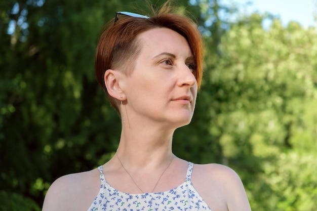 Closeup portrait of a redhaired woman with a short haircut